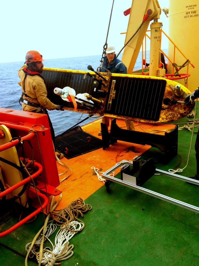 Matt Boyer (left) and Jim Thomson retrieve the Wave Glider in March from off the coast of Argentina.University of Washington