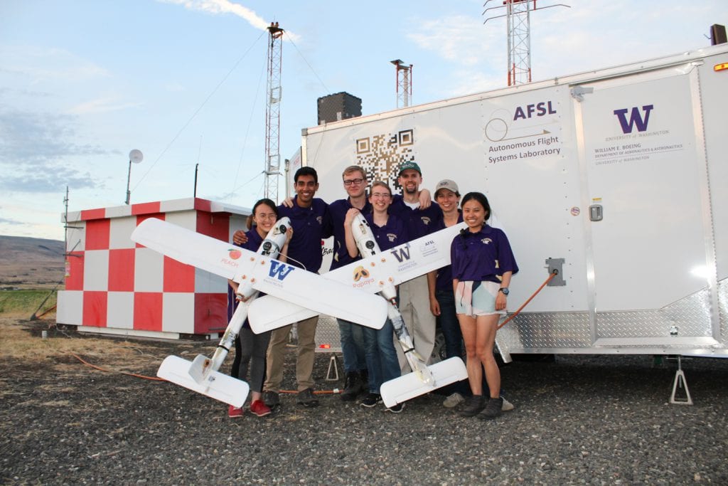 The team holding Peach (left) and Papaya (right) in front of the Autonomous Flight Systems Laboratory’s ground station trailer and the antenna array. From left to right: Kelly Lee, Ravi Patel, Joshua Brockschmidt, Helen Kuni, Cory Cantey, Hannah Rotta and Karine Chen.Credit: Autonomous Flight Systems Laboratory