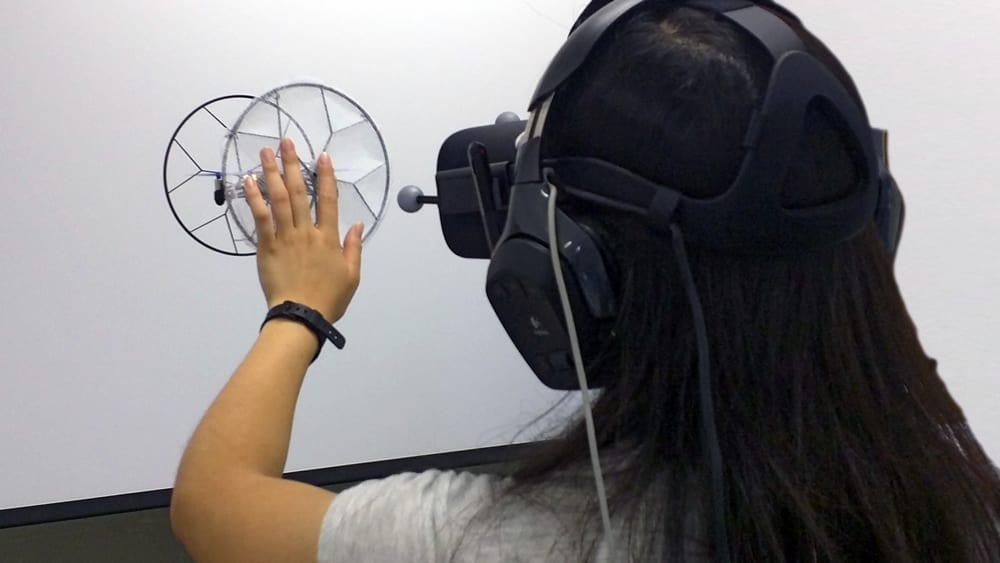  Participant exploring the virtual balloon during the first user study through touching and pushing.