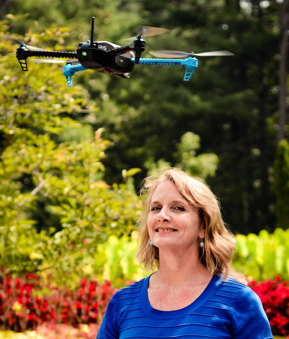 This is Mary 'Missy' Cummings standing with a hovering drone in the Sarah P. Duke Gardens at Duke University, where she will work to generate a set of inexpensive, unobtrusive best practices to deter unwanted drone usage.