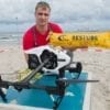 Copterpilot Thomas Wodrig from the DRK Water Rescue presents a so-called rescue-copter on 22.08.2017 on the beach of Bansin (Mecklenburg-Vorpommern) on the island of Usedom. On the beaches of Mecklenburg-Vorpommern this is the first test of drones. At about 65 kilometers per hour, the drone flies over the Baltic Sea to the casualty and flops a buoyancy aid next to the victim into the water. The package inflates to a yellow tube. Photo: Stefan Sauer