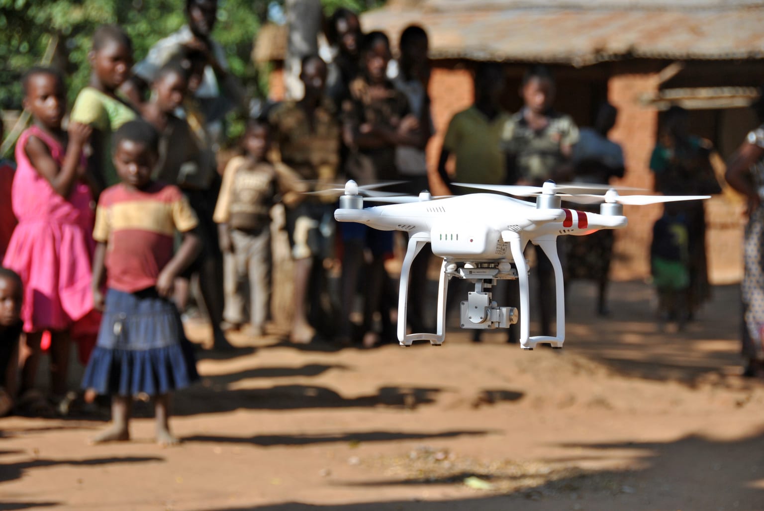 A drone operated by Chief Air Traffic Controller Steve Mkandawire, one of five Civil Aviation certified pilots, takes off during a demonstration for residents in Thipa vllage, Kasungu District, Malawi, Thursday 29 June 2017. Thipa village is 19 kilometres from the nearest health centre in Dwangwa and the only way to get there is either by bicycle or walking for four hours. On 29 June 2017, the Government of Malawi and UNICEF launch an air corridor to test potential humanitarian use of Unmanned Aerial Vehicles (UAVs), also known as drones. The corridor is the first of its kind in Africa and one of the first globally with a focus on humanitarian and development use. It is centred on Kasungu Aerodrome, in central Malawi, with a 40 kilometre radius (80 kilometre diameter) and is designed to provide a controlled platform for the private sector, universities and other partners to explore how UAVs can be used to help deliver services that benefit communities. The UAV corridor will run for at least one year, until June 2018. Since the announcement in December 2016, 12 companies, universities and NGOs from around the world have applied to use the corridor. These include drone manufacturers, operators and telecom companies such as GLOBHE (Sweden) in collaboration with HemoCue and UCANDRONE (Greece), and Precision (Malawi), all of which were present at the launch to demonstrate connectivity, transportation and imagery uses respectively. UAV technology is still in the early stages of development. UNICEF is working globally with a number of governments and private sector partners to explore how UAVs can be used in low income countries. All projects adhere to a strict set of innovation principles, with a focus on open source and user-centred design.
