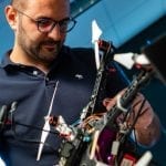 Postdoctoral researcher Riccardo Petrolo adjusts a gas-sensing drone in a Rice University laboratory.