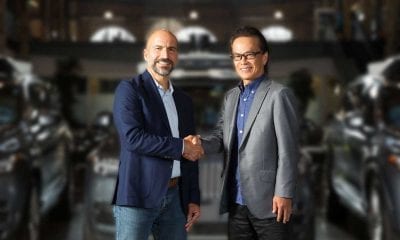 Toyota and Uber execs handshake