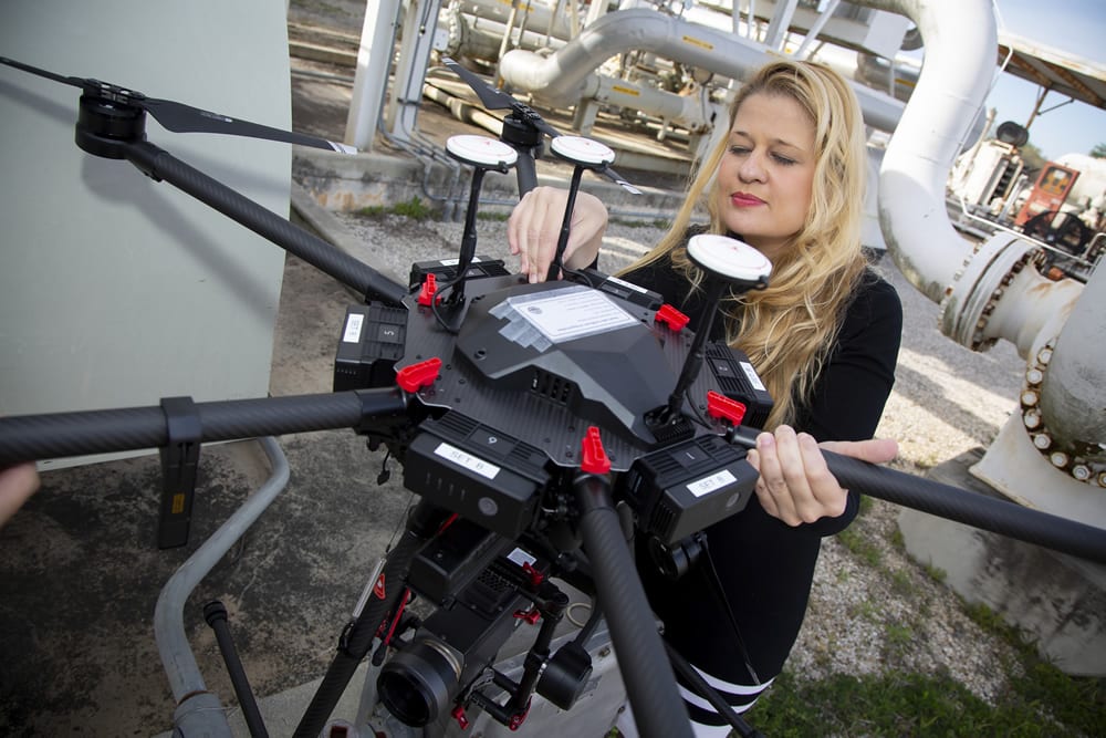 Maria Araujo inspects a drone that uses midwave infrared cameras (MWIR) to autonomously detect methane leaks. SwRI’s Smart LEak Detection System (SLED) uses computer vision and machine learning to detect pipeline leaks from aerial drones. Credit: Courtesy of Southwest Research Institute
